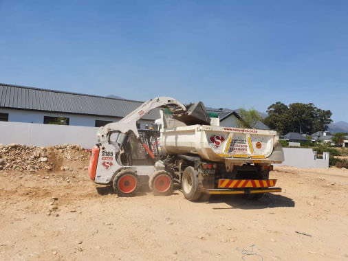 TLB and digger loader on construction site